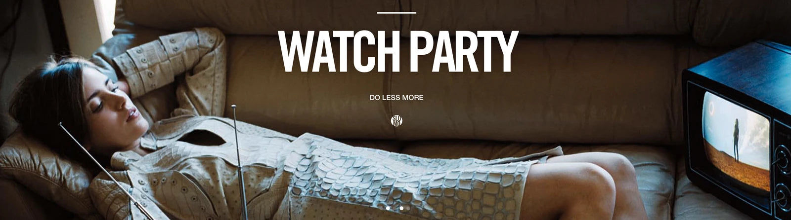 Watchparty: someone stretches out on a sofa in front of the television.